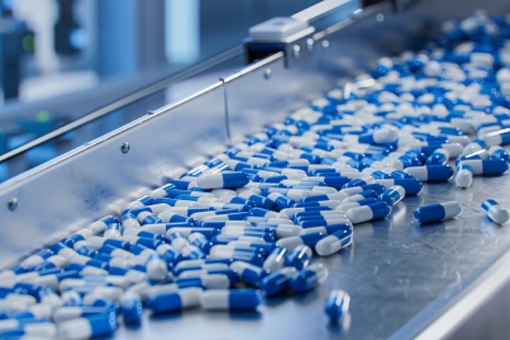 Capsules moving along a pharmaceutical production line